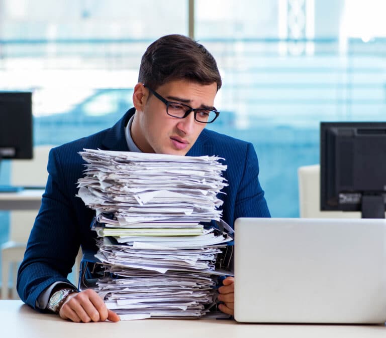 Businessman,Workaholic,Struggling,With,Pile,Of,Paperwork